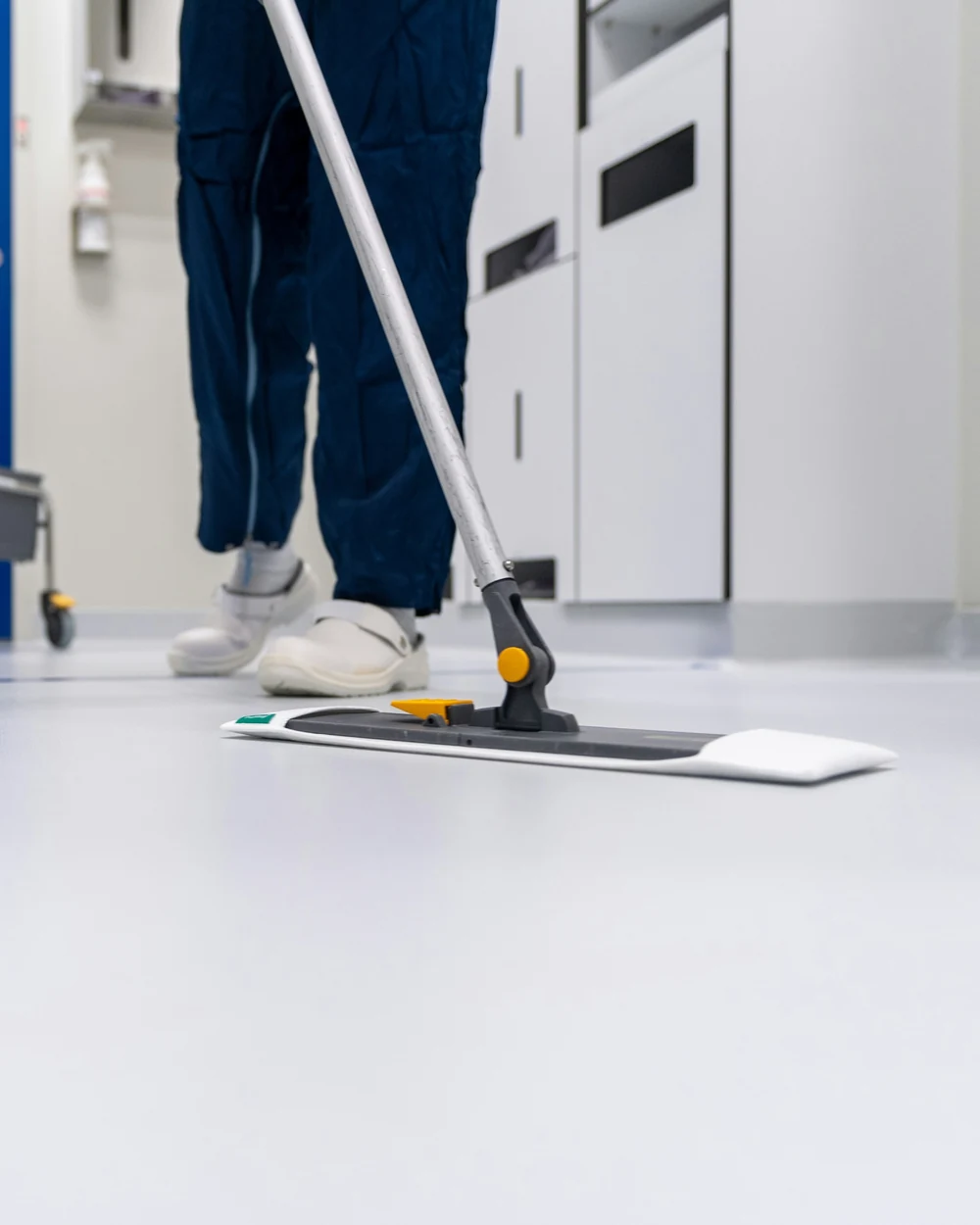 Commercial cleaner mopping a hard floor on site in Echuca